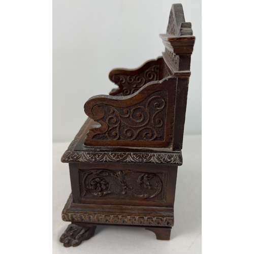 1309 - A late Victorian sewing box modelled as a highly carved monks bench with claw feet. With ornately ca... 