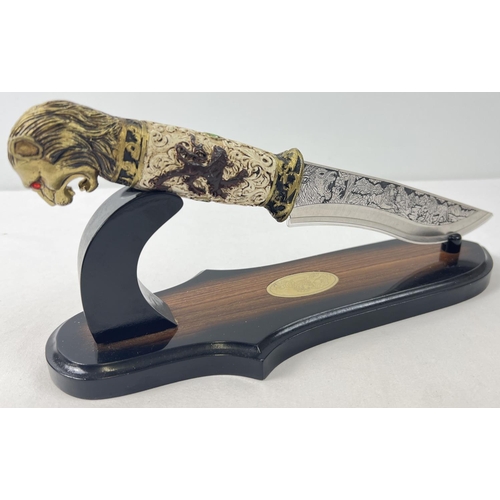 1175 - An ornamental knife with resin lions head detail to handle. Scroll and floral detail to handle and e... 