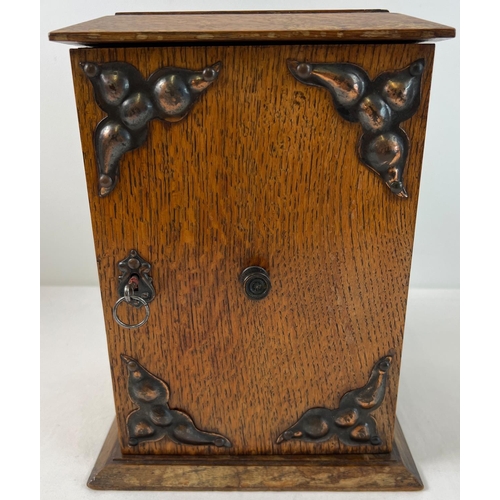 1313 - An early 20th century oak smokers cabinet with Arts & Crafts style copper panels applied to door. 2 ... 