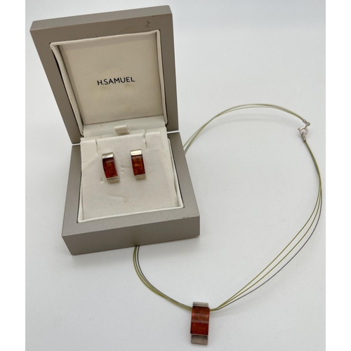 1073 - A boxed silver & amber modern design necklace & matching earrings set with cognac amber. Pendant on ... 