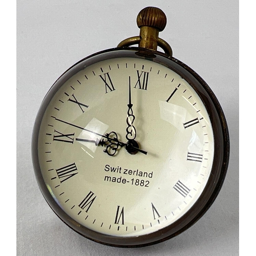 1200 - A top winding glass ball watch, bound in brass with roman numeral markers. Approx. 6cm diameter. In ... 