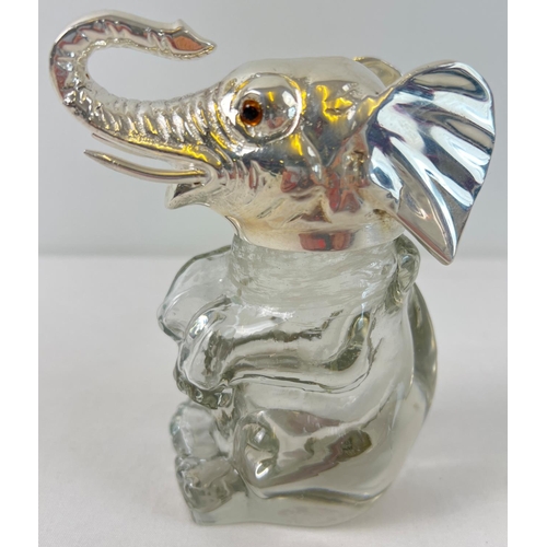 1110 - A clear glass bottle/decanter modelled as an elephant with a silver plated lid and rim. With brown g... 