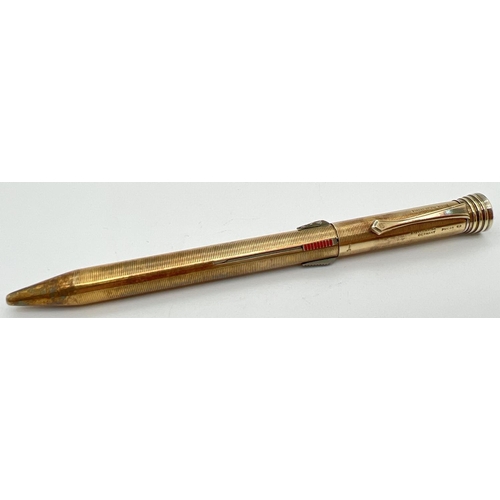 1132 - A vintage gold plated on silver Super-Norma Mecan multi coloured propelling pencil. Engine turned de... 