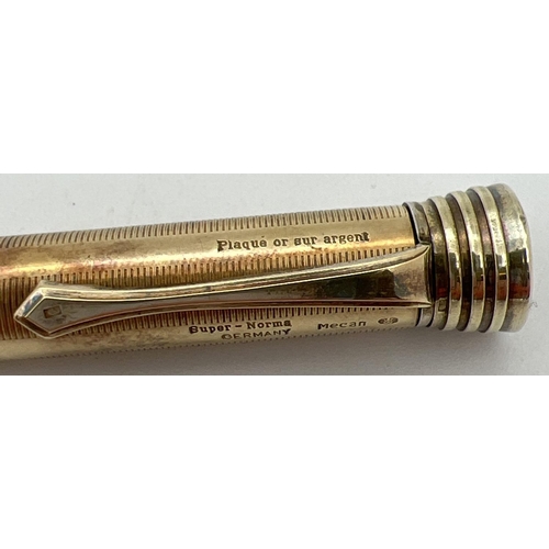 1132 - A vintage gold plated on silver Super-Norma Mecan multi coloured propelling pencil. Engine turned de... 