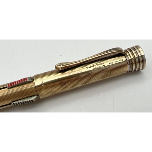 1132 - A vintage gold plated on silver Super-Norma Mecan multi coloured propelling pencil. Engine turned de... 