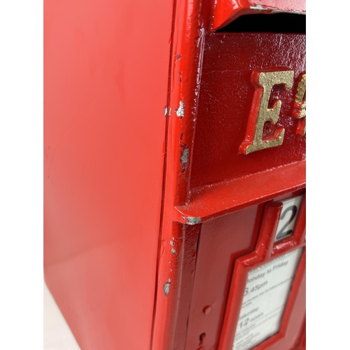 1141 - A full sized, red painted, cast metal ER post box with gold painted detail. Complete with keys.