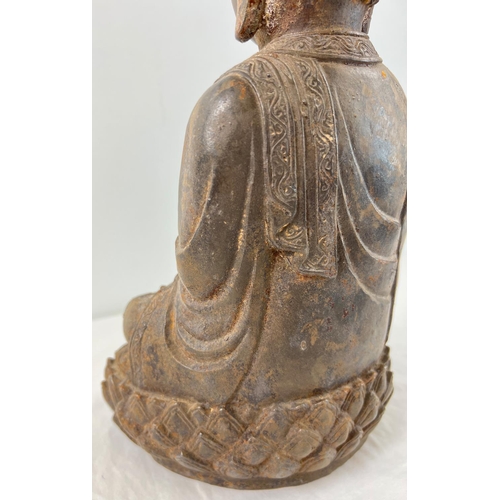 1271 - A Chinese hollow metal figure of Buddha sitting on a lotus flower. Approx. 33cm tall and weighs appr... 