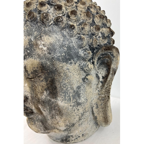 1404 - A large weathered concrete effect resin ornamental Buddha head. Approx. 45cm tall.