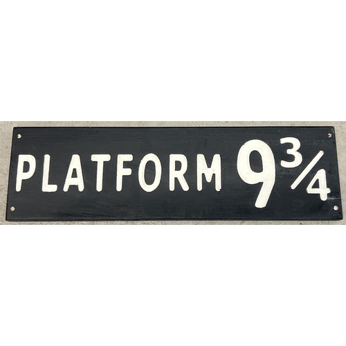 1324 - A modern painted wood Harry Potter Platform 9¾ sign, in black & white. Approx. 59cm long.