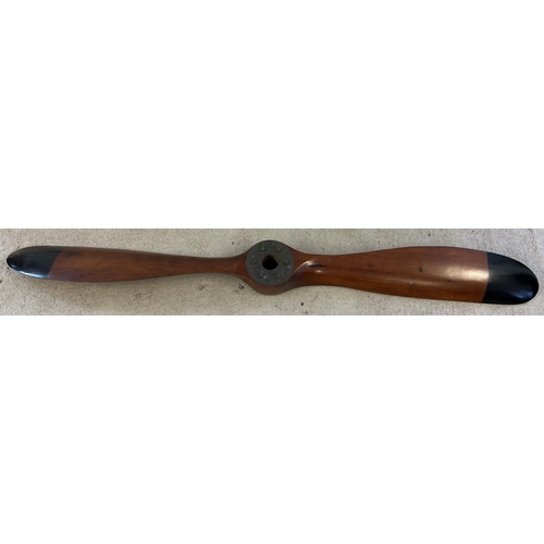 1330 - A very large wooden propellor with black painted tips. Approx. 195cm long.