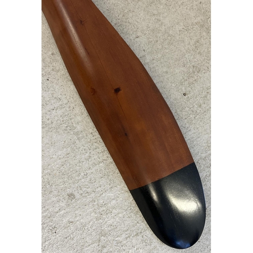 1330 - A very large wooden propellor with black painted tips. Approx. 195cm long.