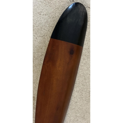 1330 - A very large wooden propellor with black painted tips. Approx. 195cm long.