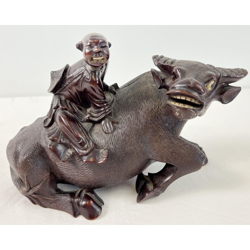 1273 - An antique carved hardwood Oriental figure of a Chinese man atop a water buffalo. Carved from one pi... 