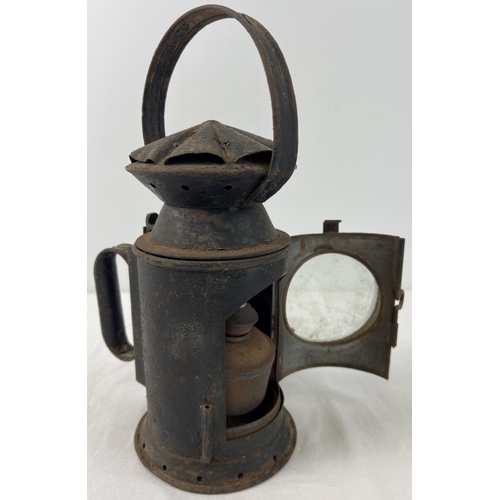 1151 - A 1943 black painted railway lamp with clear glass front and Sherwood's ceramic wick holder. Marked ... 