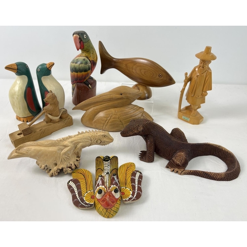 1336 - A collection of carved wooden animals and figures, some painted. To include parrot, pelican, lizards... 