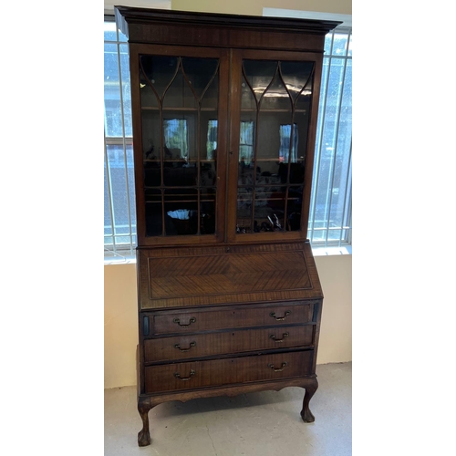 1436 - An early 20th century dark wood bureau bookcase raised on 4 ball & claw feet. 2 door glazed bookcase... 