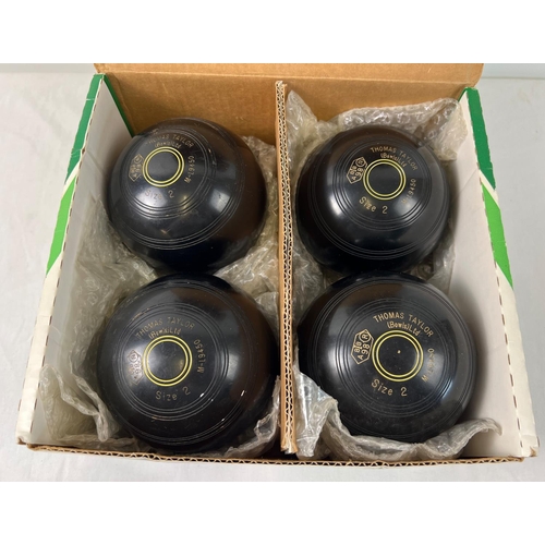 1338 - A set of 4 Thomas Taylor Lignoid lawn bowls. Size 2 mediumweight M-9450. In original box.