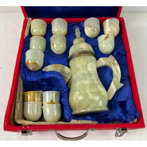 1339 - A boxed green onyx ethic style coffee pot with 12  matching coffee beakers. Metal banding to base of... 