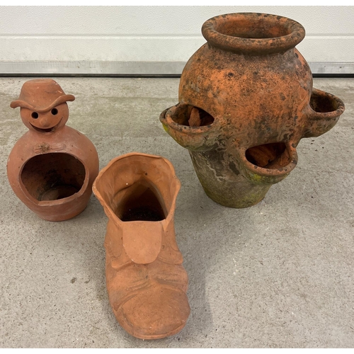 1412 - 3 terracotta garden pots. A strawberry pot (approx. 36cm tall) together with a boot and snowman plan... 