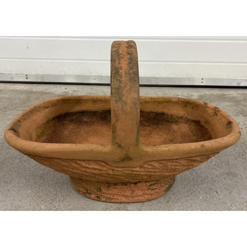 1413 - A large terracotta garden planter in the shape of a flower basket. Approx. 40cm tall x 60cm long.