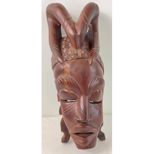 1275 - A large African hand carved heavy wood tribal mask, possibly African Mahogany. Approx. 48cm tall.