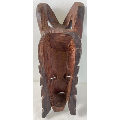 1275 - A large African hand carved heavy wood tribal mask, possibly African Mahogany. Approx. 48cm tall.