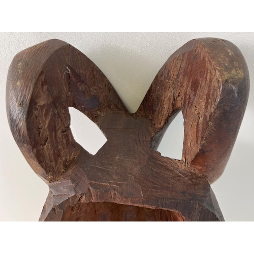 1275 - A large African hand carved heavy wood tribal mask, possibly African Mahogany. Approx. 48cm tall.