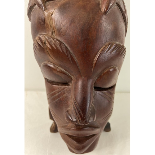 1275 - A large African hand carved heavy wood tribal mask, possibly African Mahogany. Approx. 48cm tall.