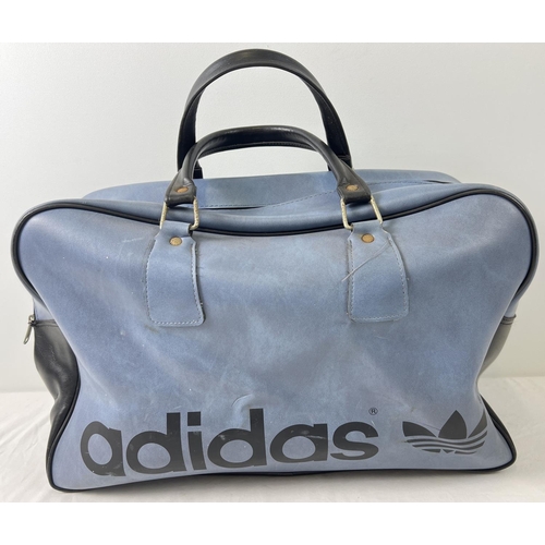 1365 - A vintage blue and black classic design Adidas holdall. Adidas name to front with 2 carry handles an... 