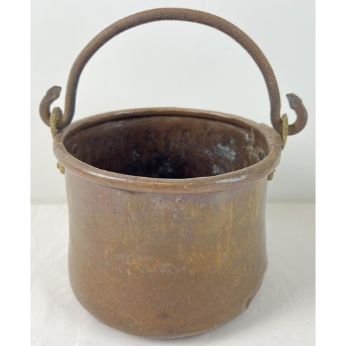 1153 - An antique copper and brass cooking pot with riveted iron swing handle. Approx. 14cm tall (excluding... 