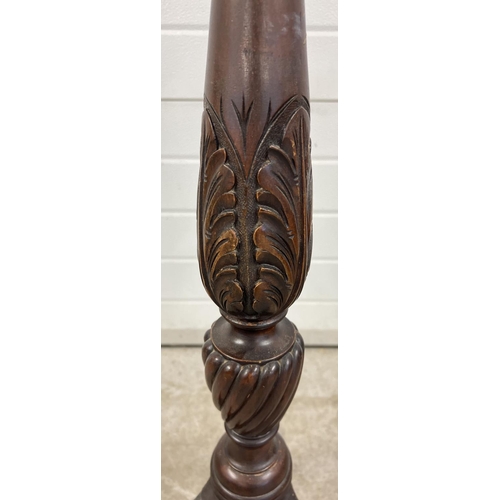 1446 - An antique mahogany torchere with carved floral detail to legs and pedestal. Bead rim detail to top.... 