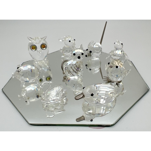 1258 - A collection of small Swarovski crystal animal figures on a mirrored stand. All etched with the squa... 