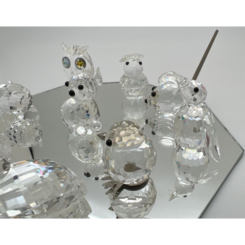 1258 - A collection of small Swarovski crystal animal figures on a mirrored stand. All etched with the squa... 