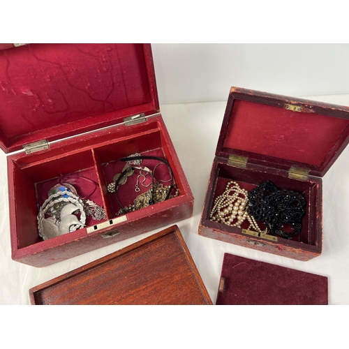 1082 - 2 vintage wooden red leather covered jewellery boxes with contents. Brass fixings and top carry hand... 