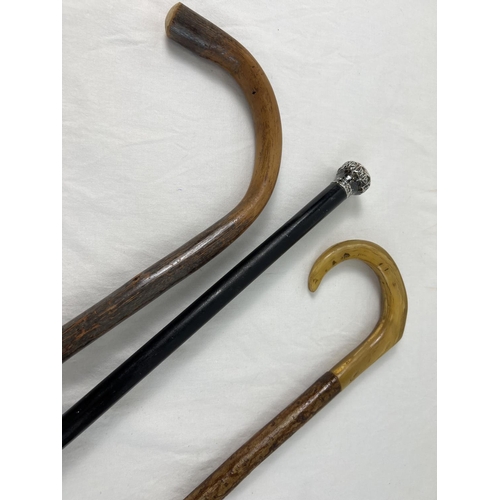 1351 - An antique silver topped walking cane together with a horn handled walking stick and a vintage woode... 