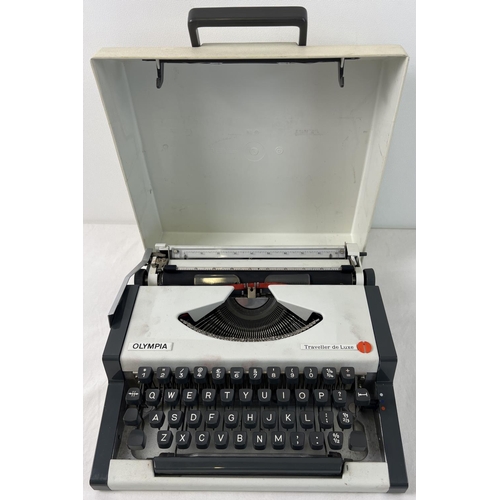 1353 - A vintage Olympia Traveller plus typewriter with carry case lid in grey and white. Approx. 30 x 31.5... 