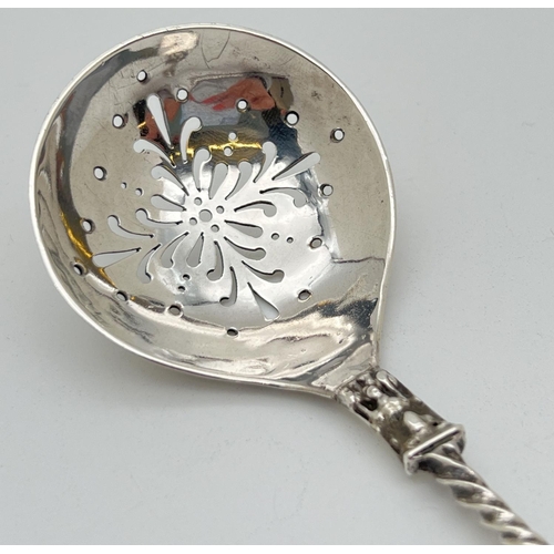 1126 - A Victorian silver sugar sifting spoon with pierced bowl and apostle style finial with twisted handl... 