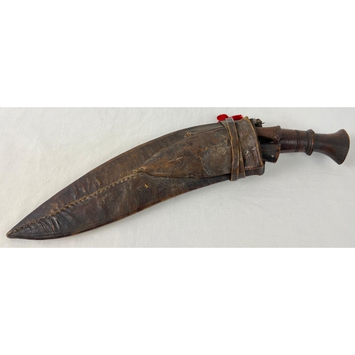 1192 - A vintage leather sheathed, curve bladed Gurkha Kukri knife, with 2 small karda knives - 1 not origi... 