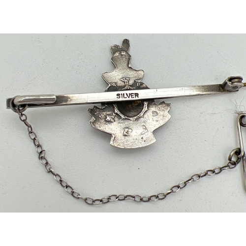 1197 - A silver Royal Marine sweetheart pin back brooch with enamelled detail and safety chain. Stamped sil... 