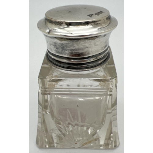 1128 - An early 20th century James Deakin & sons silver lidded cut glass bottle with interior glass stopper... 