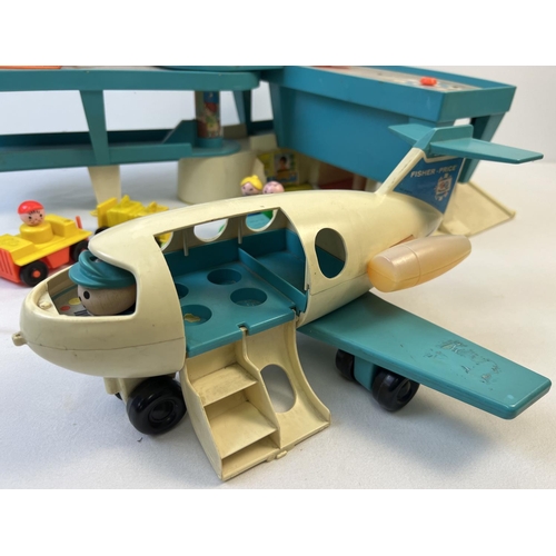 1361 - A vintage Fisher Price Airport. With passenger plane, helicopter, luggage carts, cars, figures and j... 