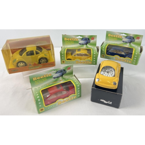 1445 - A collection of boxed novelty Volkswagen Beetle shaped collectables. Comprising: 3 diecast lighters,... 