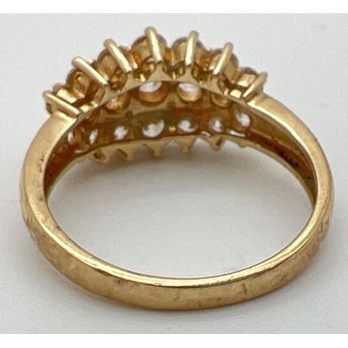 1118 - A 14ct gold claw set cluster ring with 19 round cut Diamonique cubic zirconia stones. Full hallmarks... 