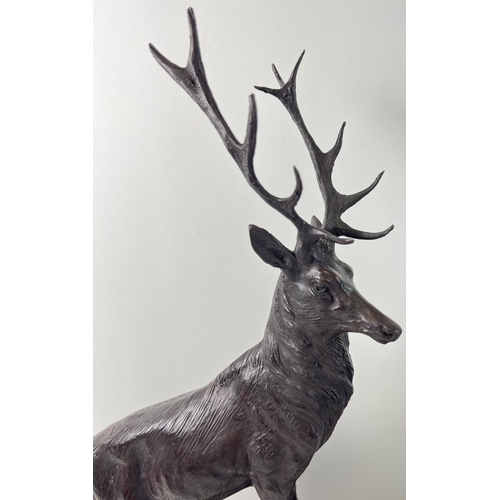 1203 - A pair of very large bronze left & right facing stag figures mounted on black marble bases. Each app... 