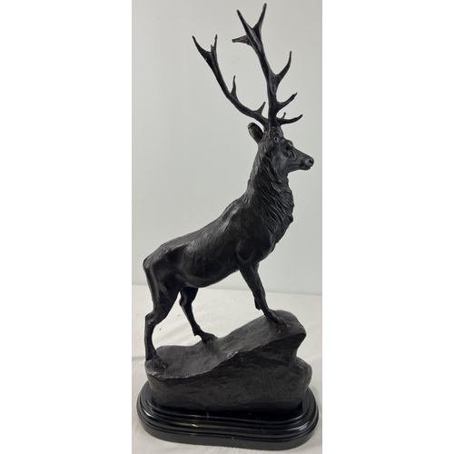 1203 - A pair of very large bronze left & right facing stag figures mounted on black marble bases. Each app... 