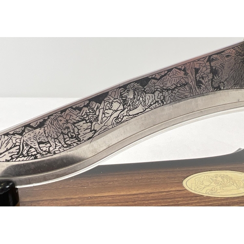 1230 - An ornamental knife with resin lions head detail to handle. Scroll and floral detail to handle and e... 