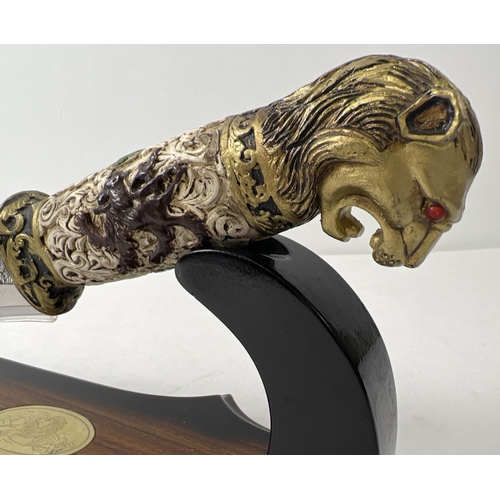 1230 - An ornamental knife with resin lions head detail to handle. Scroll and floral detail to handle and e... 