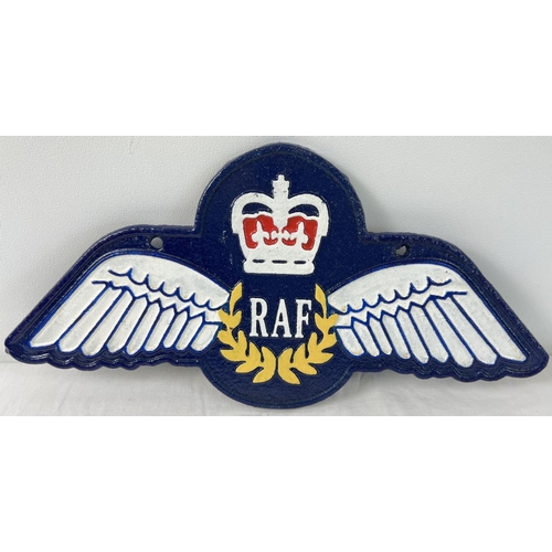 1231 - A painted cast iron RAF wings wall plaque, with fixing holes. Approx. 35cm long.