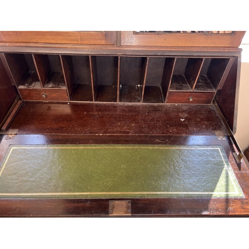 1544 - An early 20th century dark wood bureau bookcase raised on 4 ball & claw feet. 2 door glazed bookcase... 