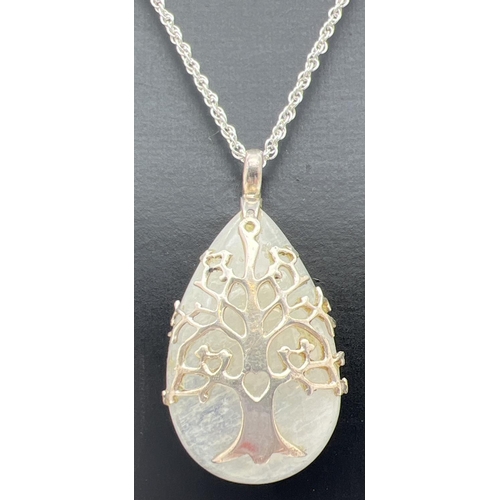 1001 - A modern design teardrop shaped moonstone pendant with Tree Of Life  design silver overlay. On a 20